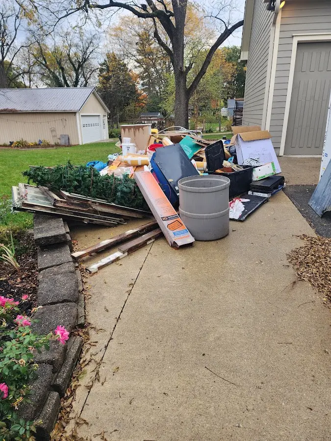 Dumpster being loaded with debris for 12 Yard Dumpster Rental in White City